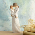 Willow Tree Tenderness, 8”h hand-painted standing resin figure holding toddler, foreheads touching, both dressed in cream, in front of blue painting
