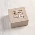 Cream wood box with hinged lid. Inset bas-relief plaque of two seated girls, facing each other.