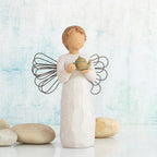 Willow Tree Angel of the Kitchen, 5.5”h hand-painted standing resin figure in cream dress with wire wings, holding green teapot, in front of sky blue painting