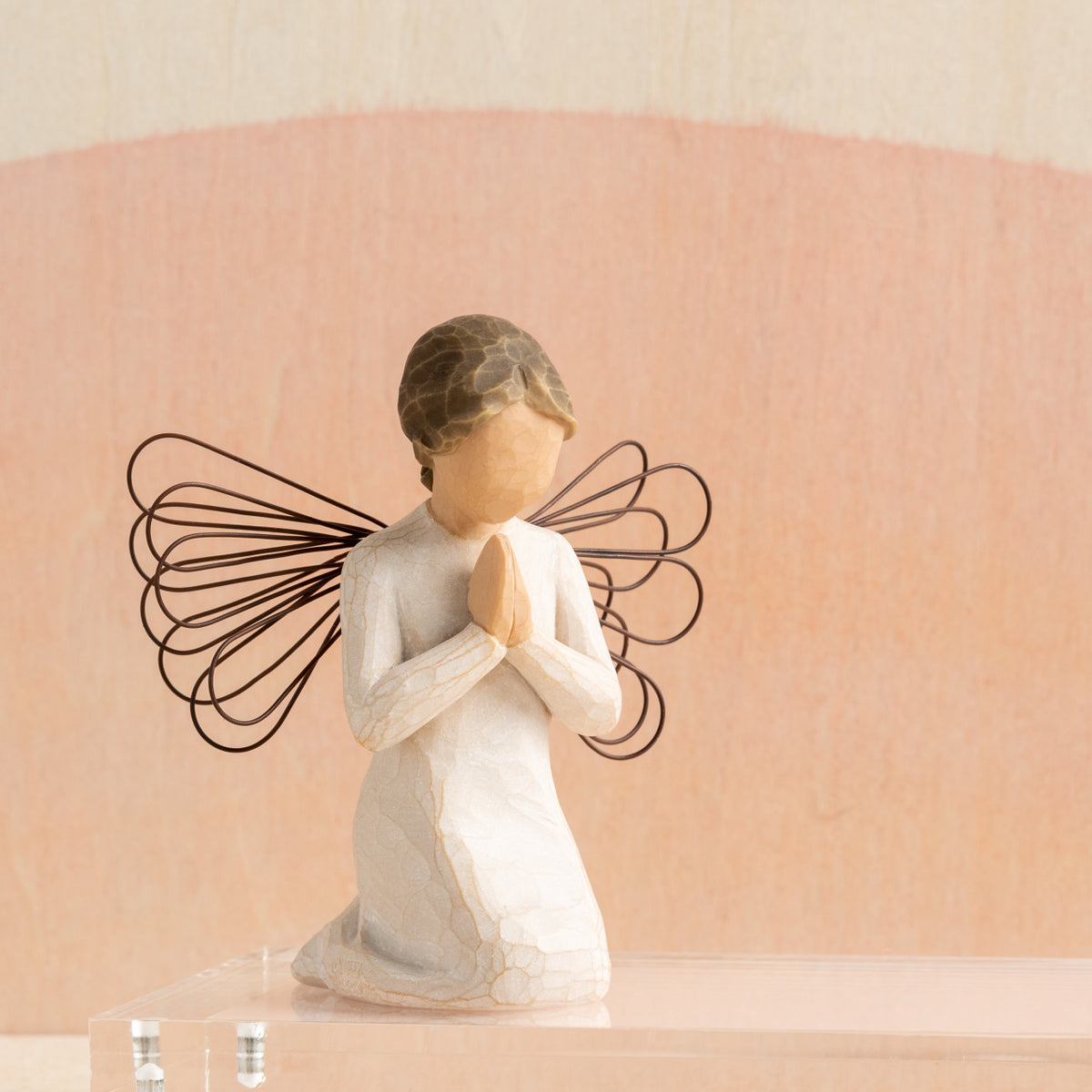Willow Tree Angel of Prayer, 4"h hand-painted resin kneeling figure in cream dress, wire wings and hands in prayer position, in front of coral painting