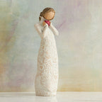 Willow Tree Je t'aime (I Love You), 8.5"h hand-painted standing resin figure holding red heart in cream dress with ruffled neck and carved with hearts, flowers and birds, in front of muted painting