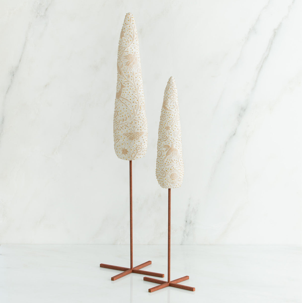 Set of two white tree figurines with wooden stands - all white background