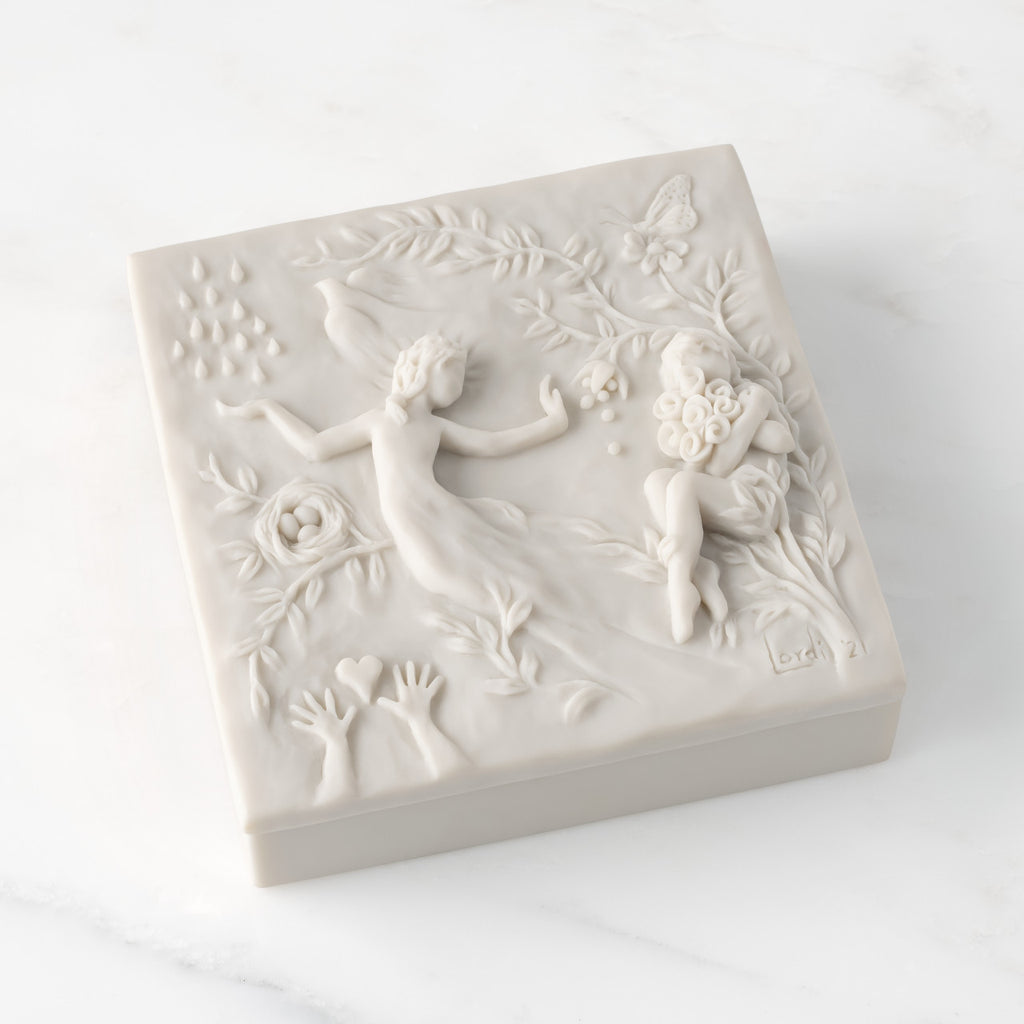 Closed white resin box; lid carved with figural and organic imagery