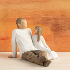 Willow Tree Father and Daughter, 5”h hand-painted resin figure of seated man dressed in neutral colors, legs outstretched, daughter in cream dress by his side, in front of sienna painting