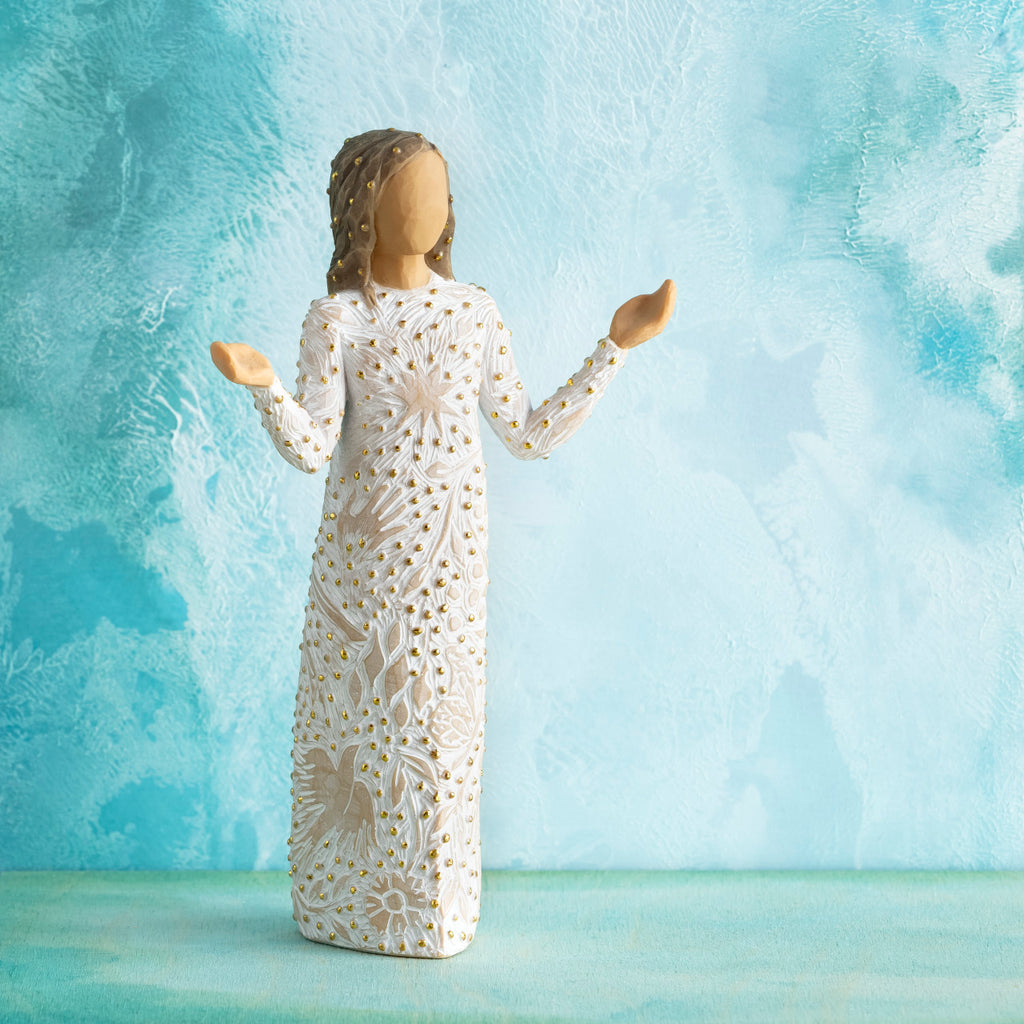 Willow Tree Everyday Blessings, 6.5”h hand-painted standing resin figure with bent elbows and arms raised, cream dress carved with nature symbols and gold-leaf dots, in front of aqua painting