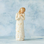 Willow Tree Tapestry, 5”h hand-painted standing resin figure, in cream dress, hands crossed at chest, entire figure carved with symbols of nature with gold-leaf, in front of blue painting