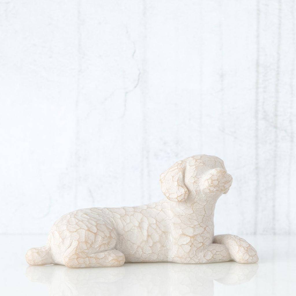 Small white dog figurine laying down