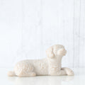 Small white dog figurine laying down