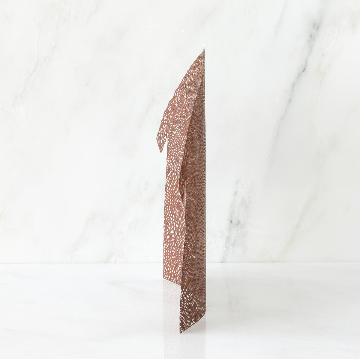 Brown figurine standing up against white background