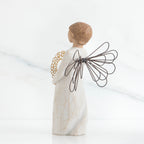 Back view of angel with short, light brown hair holding a metallic wreath of hearts with both hands