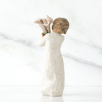 Back view of lIttle girl with short brown hair holding a cluter of white calla lilies