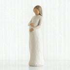 Brunette woman figurine in white holding her stomach facing forward