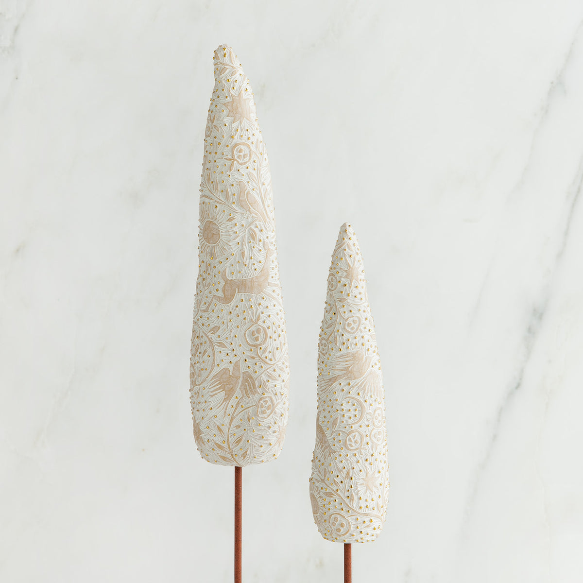 Set of two white tree figurines side by side
