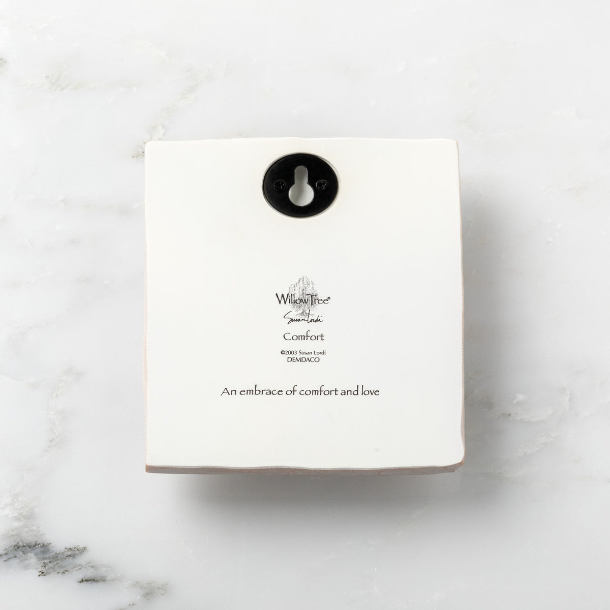 Back of white plaque reading piece title and sentiment, with Willow Tree logo