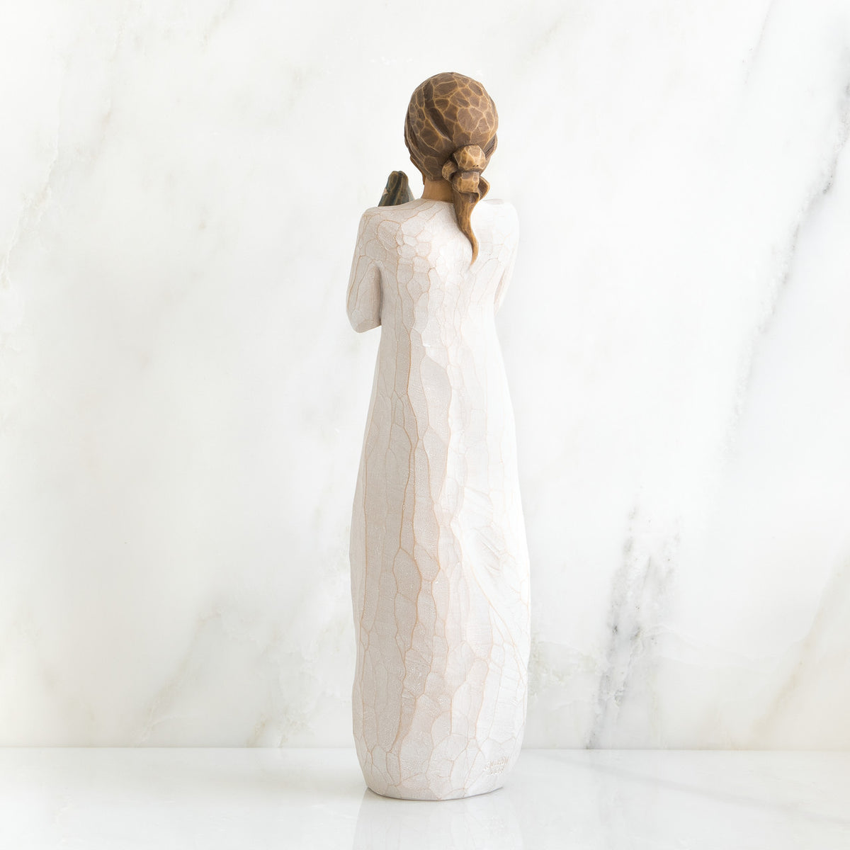 Back view of brunette woman in white dress standing up