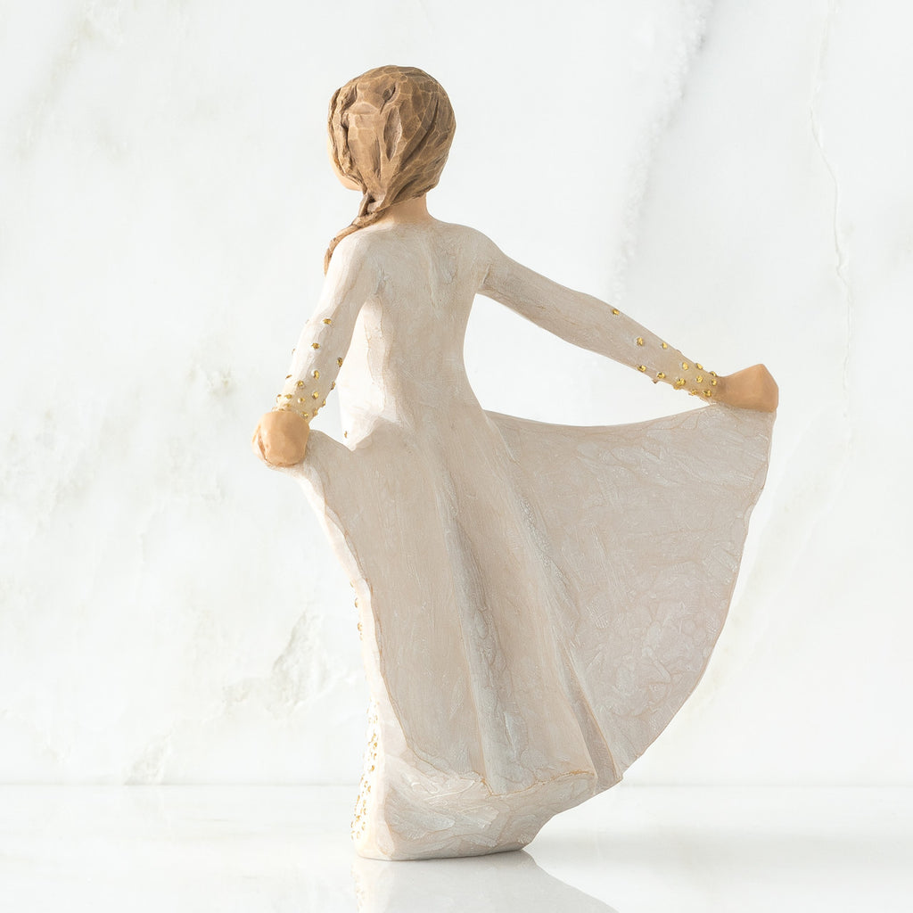 Back view of brunette woman in white dress holding up her dress