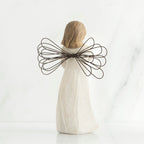 Back view of brunette girl figurine with brown wire wings standing up