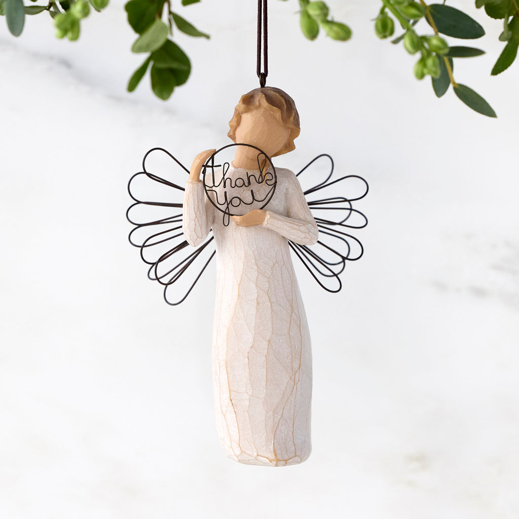 Female angel figure with wire wings holding wire circle with "thank you" written in wire inside of it, ornament loop on figure's head