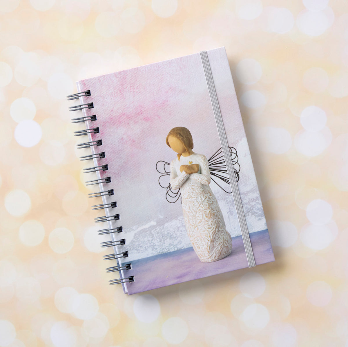 Willow Tree Remembrance Notebook, 6.5"w x 8.5"h, hard-cover, spiral-bound, 240 lined pages, front cover features Remembrance figure on background of purple-blue painting