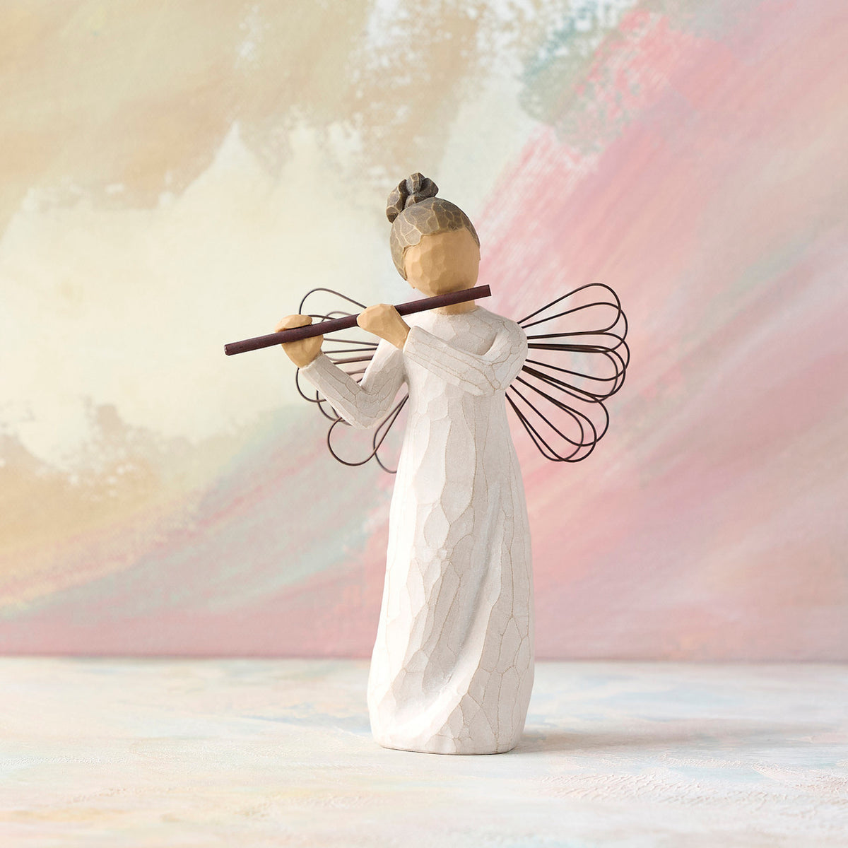 Willow Tree Angel of Harmony, 6"h hand-painted standing resin figure in cream dress with wire wings, playing the flute, in front of pale pink painting
