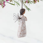 Right Side: Angel Ornament with wire wings, darker skin, dress carved with symbols of remembrance
