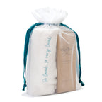 View of white towel in white see-through drawstring bag and willow tree brown box