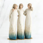 Three brunette woman figurines in white dresses blue bottoms facing forward with arms around each other