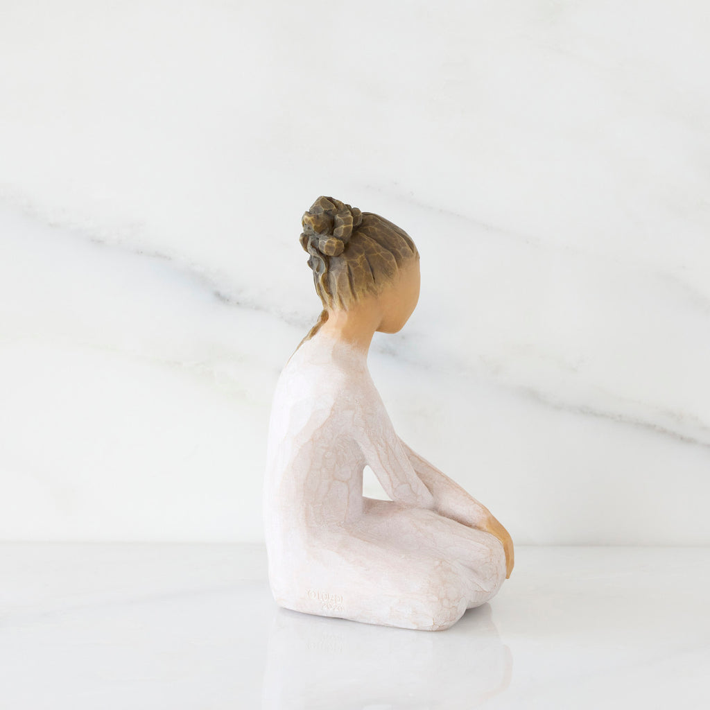 Right-facing view: seated figure in cream dress with crossed arms