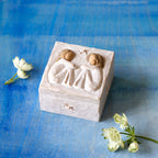 Willow Tree Friendship Keepsake Box, 3”sq x 2”h hand-painted resin box with removable lid. Lid has bas-relief carving of two seated figures in cream dresses, facing each other
