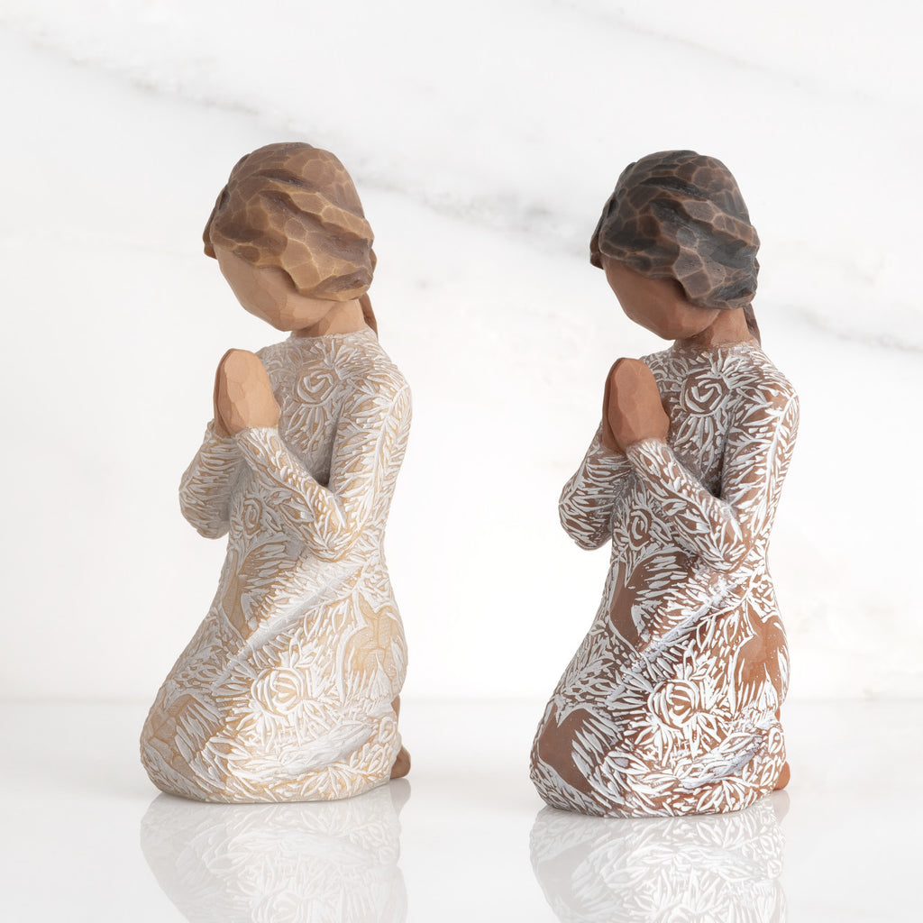 Lighter &amp; Darker skin Kneeling figures, hands in position of prayer or meditation in cream dress carved with icons of nature, lighter and darker skin versions