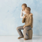 Willow Tree You and Me, 7”h hand-painted resin figure of couple; seated man, woman standing behind with arms around neck, both in neutral clothes, in front of blue painting