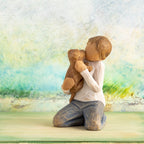 Willow Tree Kindness (boy), 3”h hand-painted resin figure of kneeling boy in neutral clothes holding golden dog, in front of light green painting