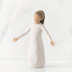 Young faceless girl figurine standing wearing all white dress with her arms out