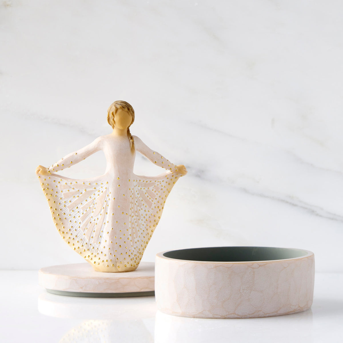 Front view: open oval resin box, showing detached lid with figure next to box base