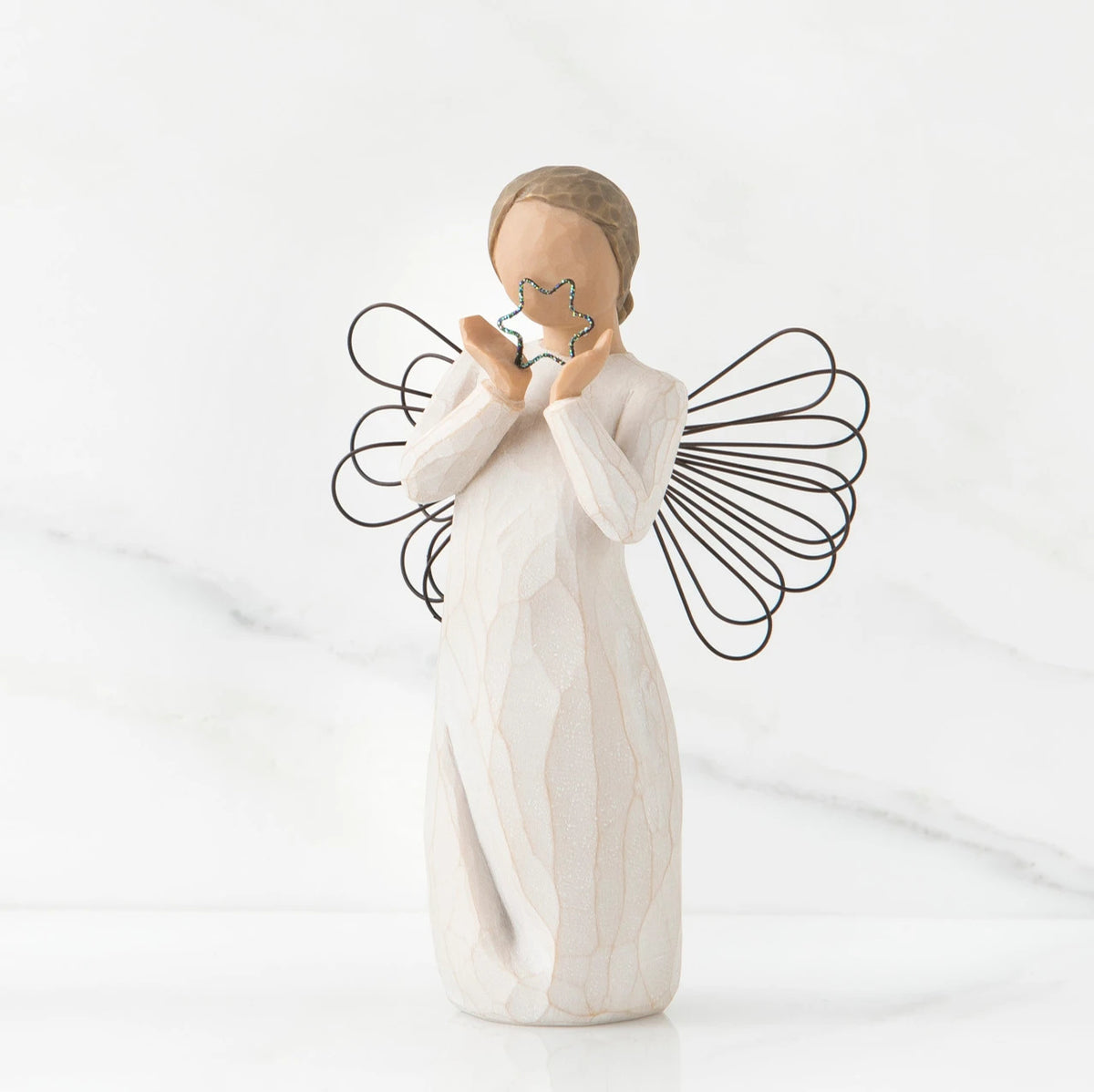 Small faceless angel girl wearing white dress, wire wings, and holding silver star