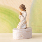 Willow Tree Prayer of Peace Keepsake Box, 3.5"oval hand-painted resin box with 3”H kneeling figure in cream dress carved with nature imagery, in prayer/meditation pose, affixed to lid, in front of green painting