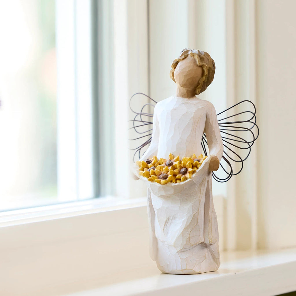 Willow Tree Sunshine, 5.5”h hand-painted standing resin angel with darker skin and hair, cream dress and wire wings, holding up skirt full of Black-Eyed Susans, on windowsill