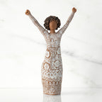 Front view of figure with natural hairstyle, arms raised overhead, dress etched with African textile patterns