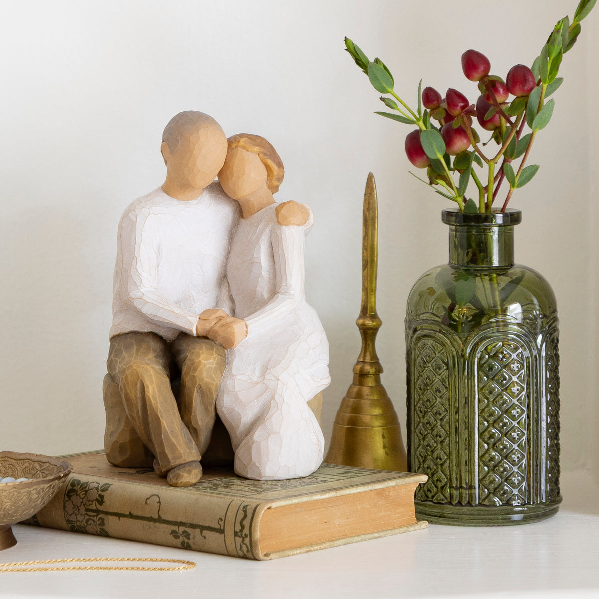 Willow Tree Anniversary, 6”h hand-painted resin figure of older couple sitting on bench holding hands, both in neutral clothing, on table with mementos