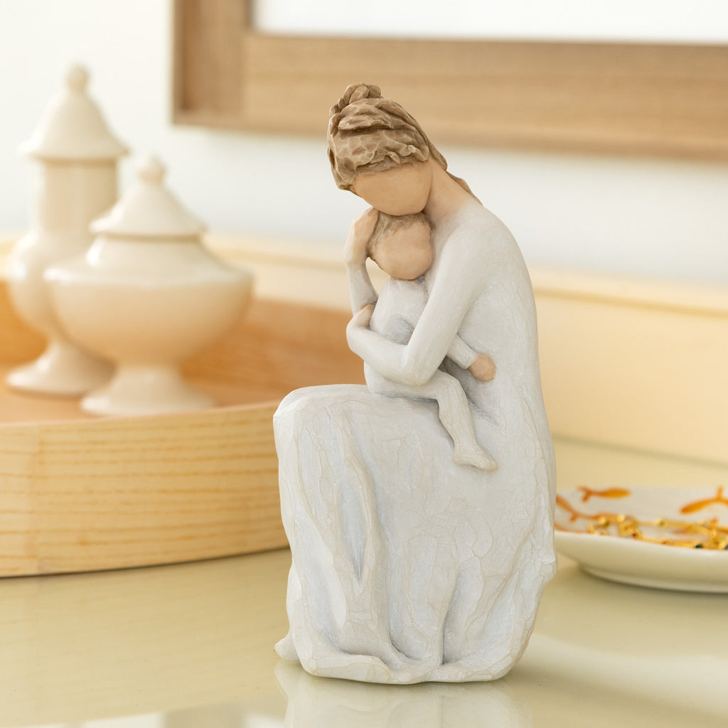 Willow Tree For Always, 6.5”h hand-painted resin female figure, seated, holding toddler on lap, both in cream clothes, arms around each other, on bedroom dresser