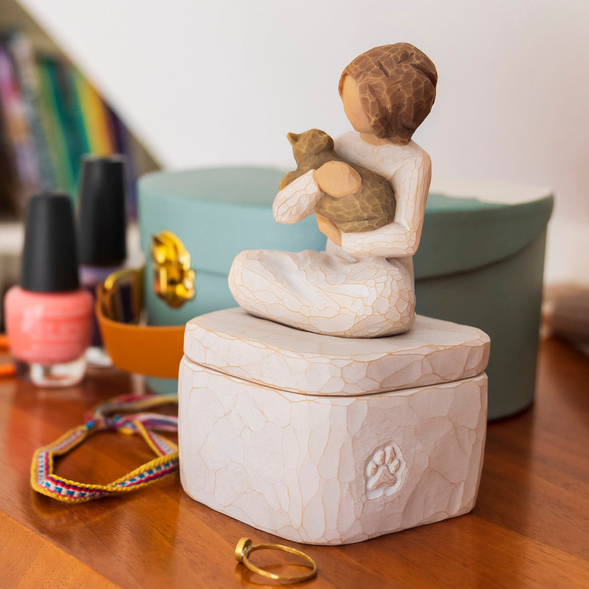 Willow Tree Kindness (girl) Keepsake Box, 3"sq hand-painted cream resin box with 3”H figure of seated girl holding cat affixed to lid, on bedside table