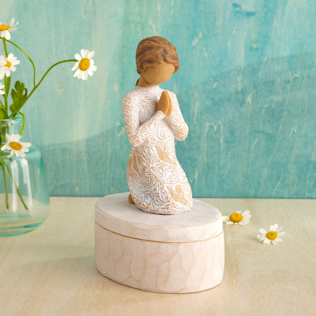 Willow Tree Prayer of Peace Keepsake Box, 3.5"oval hand-painted resin box with 3”H kneeling figure in cream dress carved with nature imagery, in prayer/meditation pose, affixed to lid, in front of teal painting